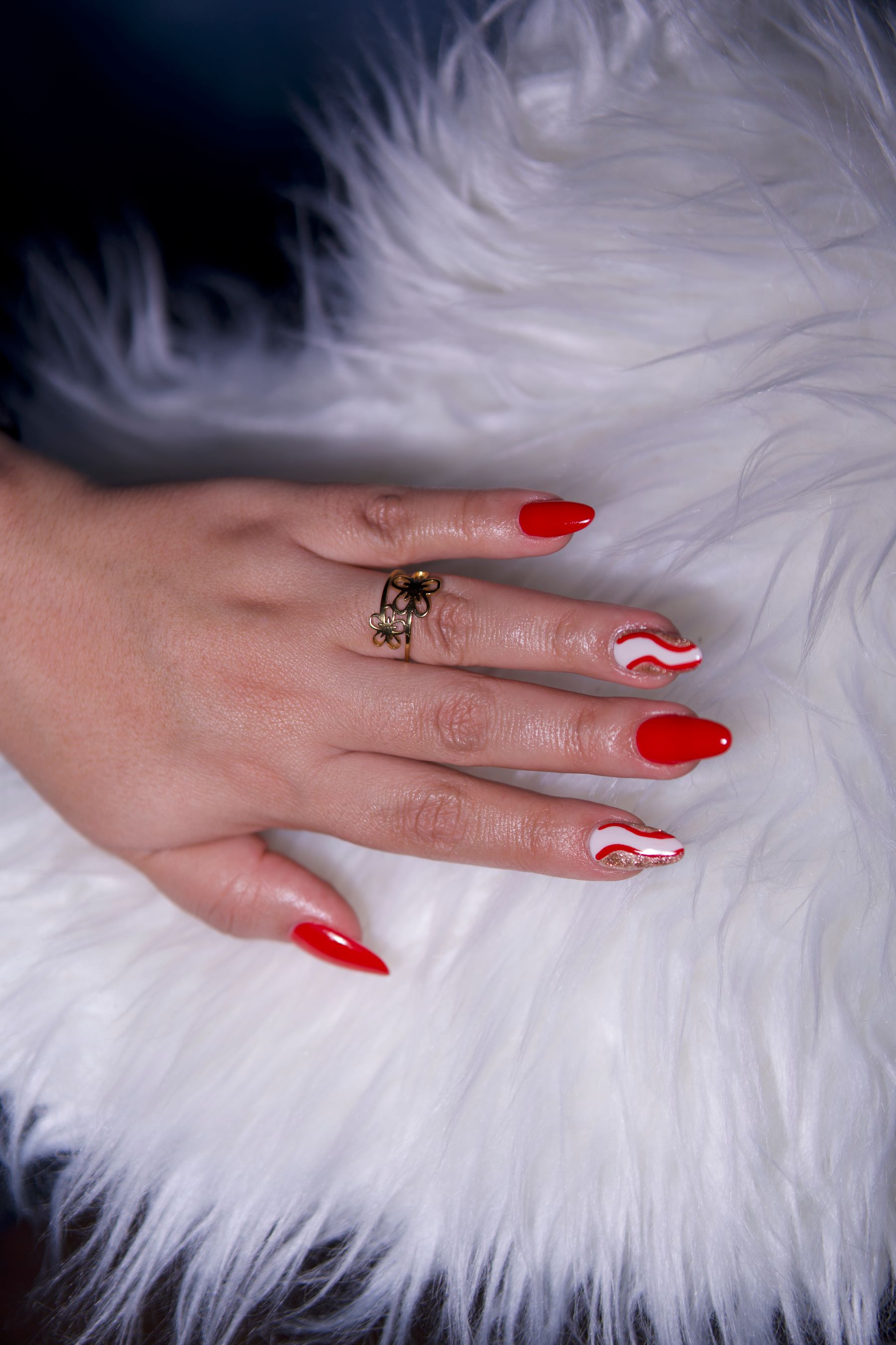 Red nail art on soft white fabric