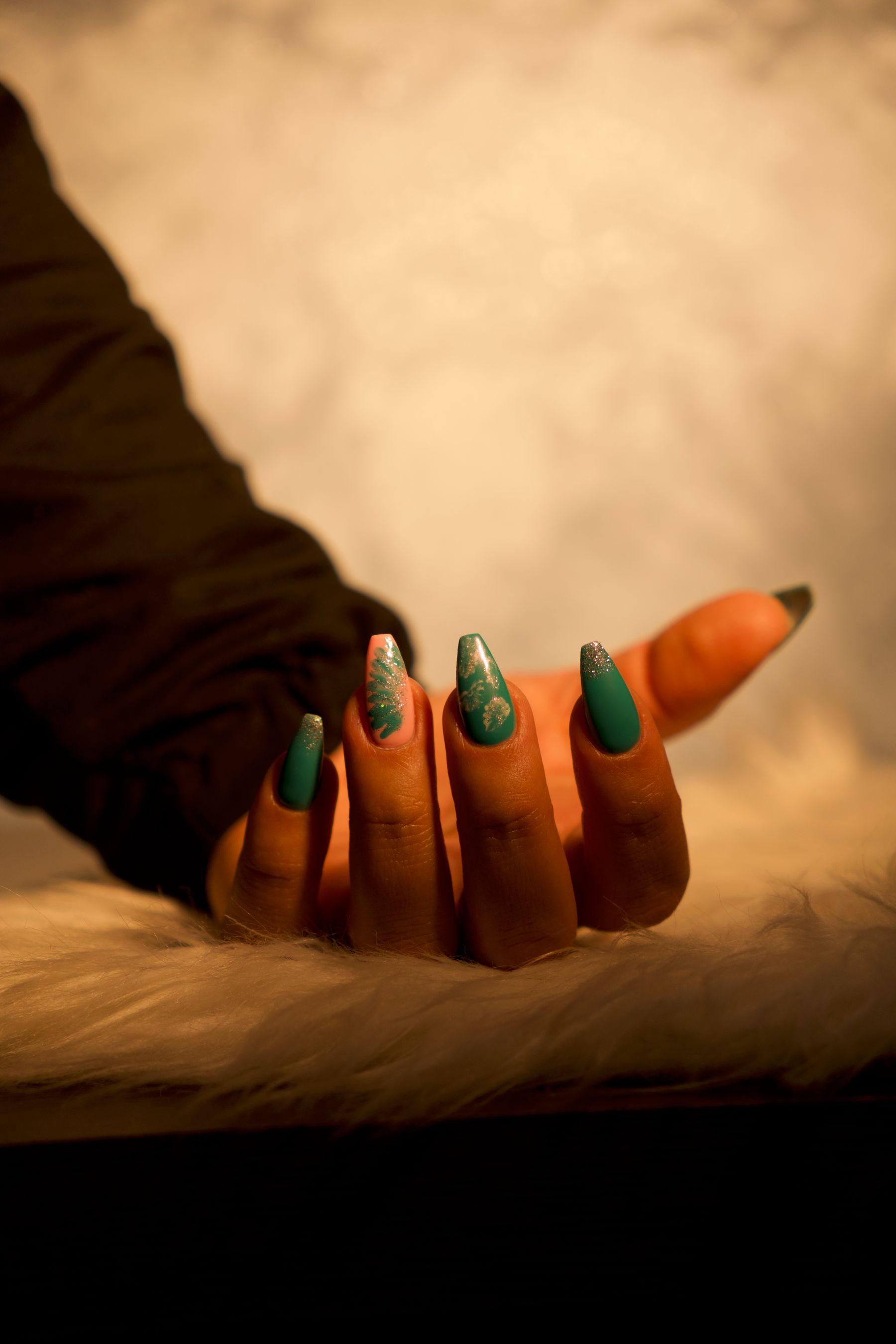 Hand with artistic teal nail design